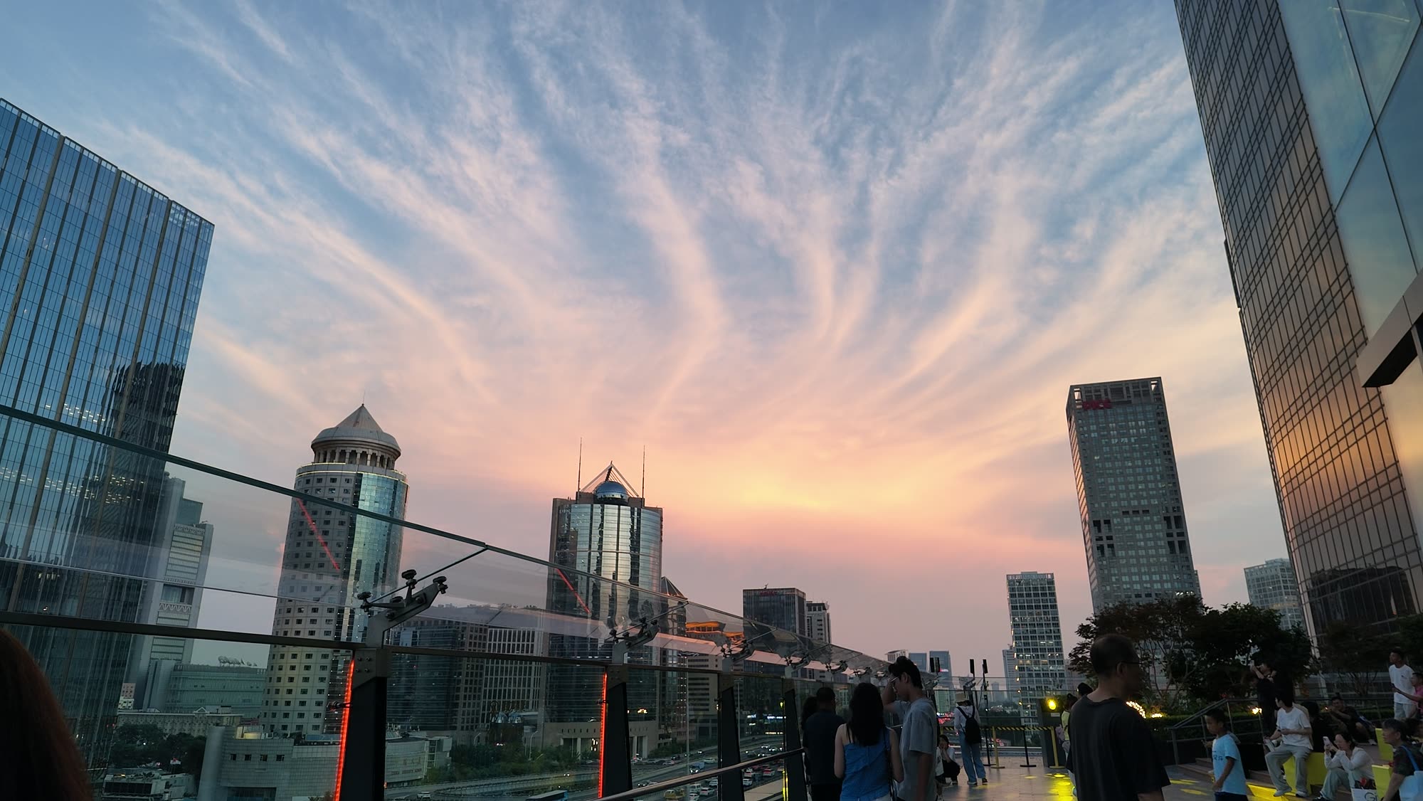 Pink evening sky over the Beijing CBD skyline, seen from a rooftop terrace